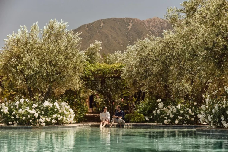 Garden and swimming pool featured in Abercrombie & Kent travel imagery.
