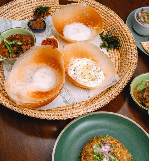 Plain hoppers, an egg hopper and accompaniments served at Amma Nissa