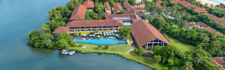 Aerial view of Anantara Kalutara Resort beside the lagoon.