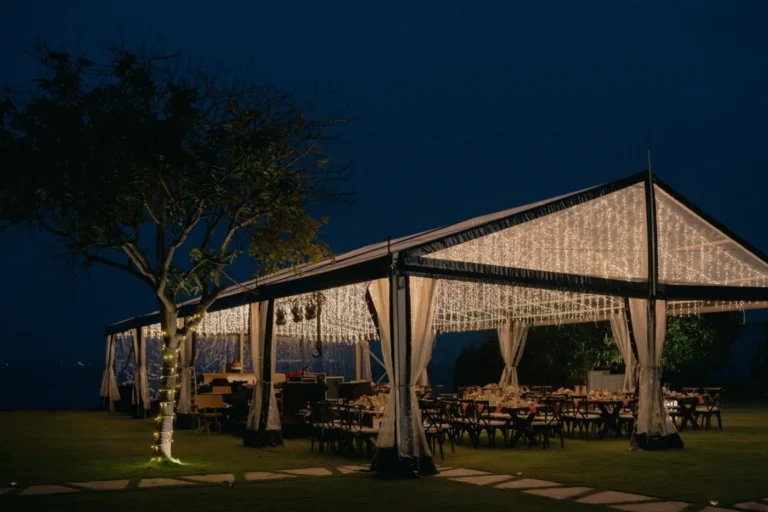 Illuminated marquee with dining tables and hanging lights, featured by Anne Suppliers