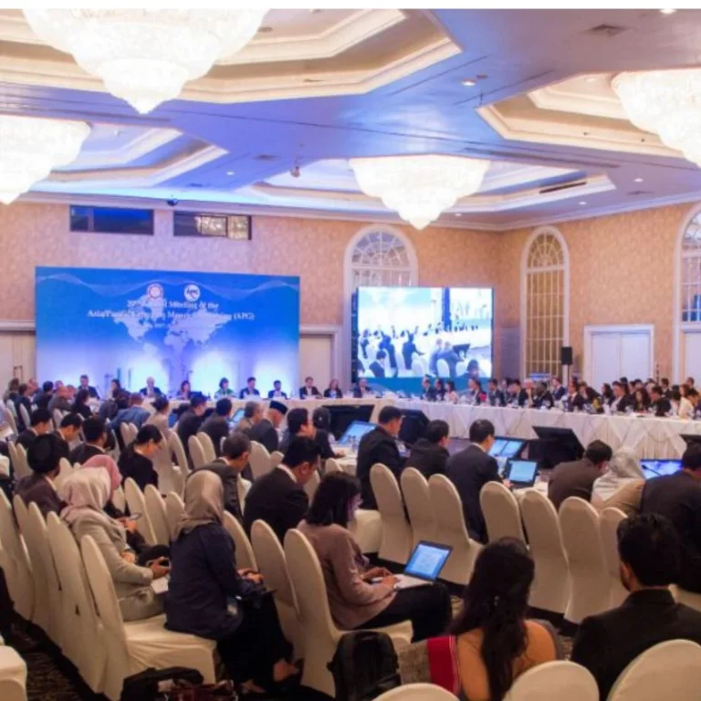 Conference audience facing a large illuminated stage, shown in AV Productions’ event portfolio