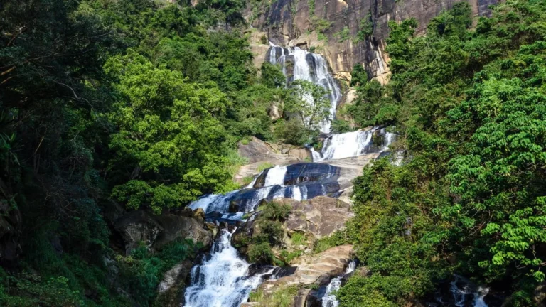 Waterfall cascading through a lush green hillside
