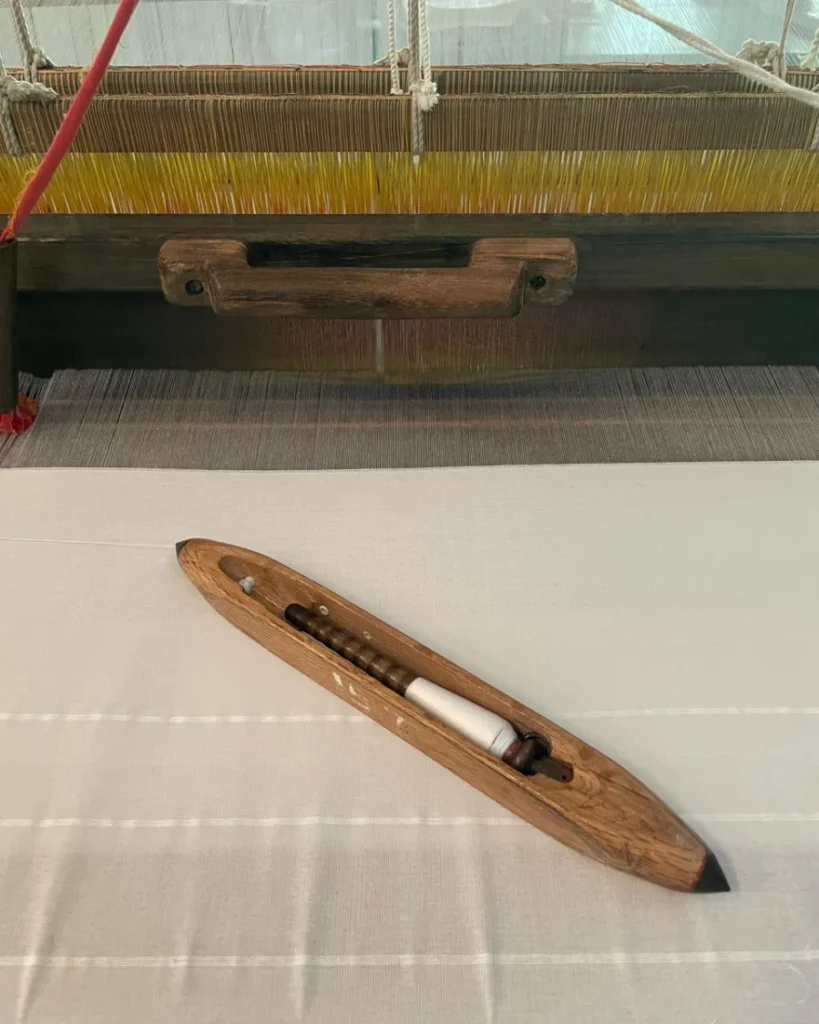Wooden weaving shuttle and handloom featured by Barefoot Ceylon