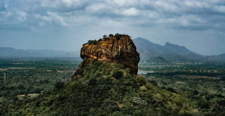 Sigiriya rock fortress rising above green forest, featured by Blue Lanka Tours