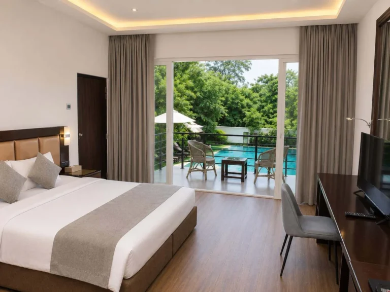 Guest bedroom opening onto a terrace with a pool view at Cassandra Culture Resort