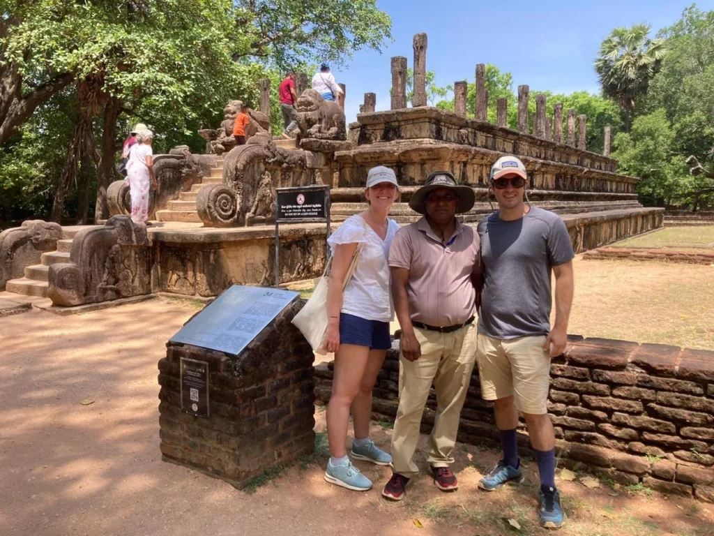 Visitors posing beside a historic site during a Ceylonwing Tours trip