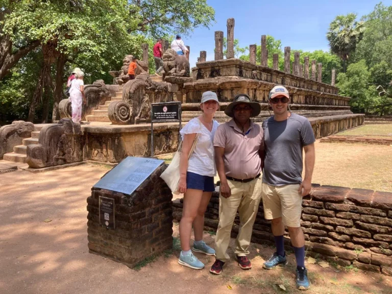 Visitors posing beside a historic site during a Ceylonwing Tours trip