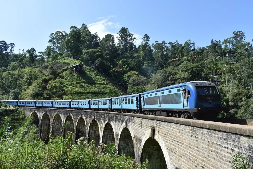 Blue train crossing the Nine Arch Bridge near Ella