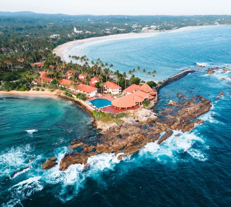Aerial view of Dickwella Resort and Spa on a rocky peninsula between beaches