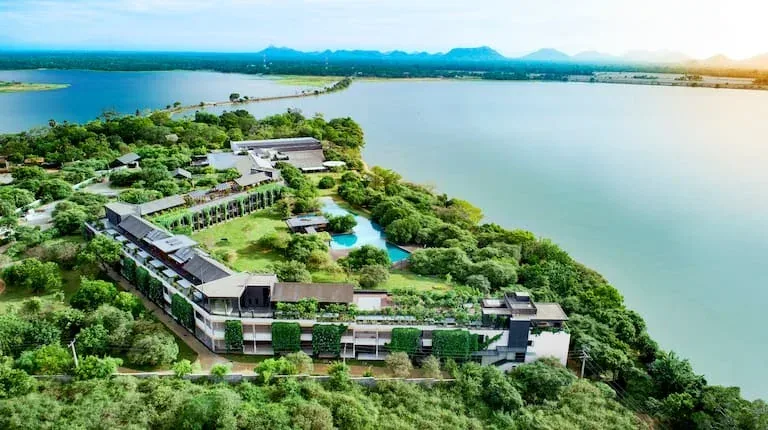 Aerial view of DoubleTree by Hilton Weerawila Rajawarna Resort beside the lake.