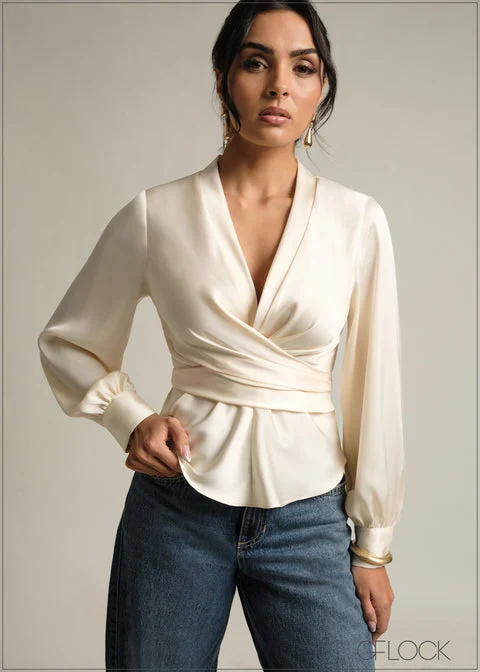 Model wearing a white tie-detail long-sleeve top from GFLOCK