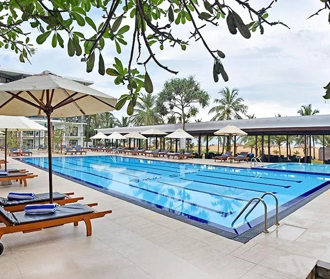 Swimming pool and outdoor seating at Goldi Sands Hotel, Negombo.