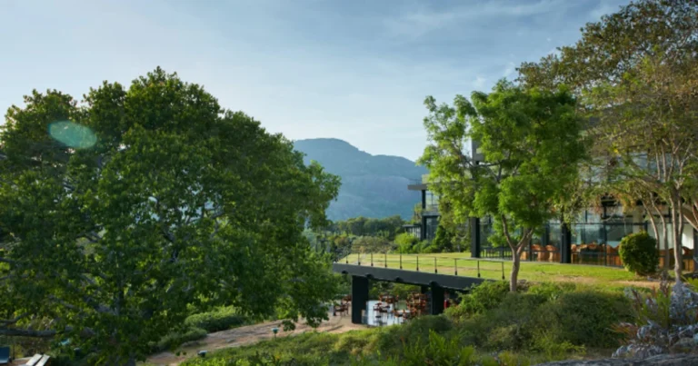 Heritance Kandalama hotel exterior amid trees with hills in the distance