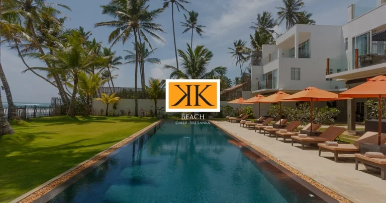 Swimming pool, palm trees and hotel buildings at KK Beach