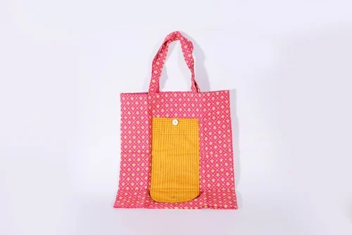 Pink woven tote bag with a yellow front pocket
