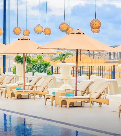 Poolside loungers and parasols at The Kingsbury hotel