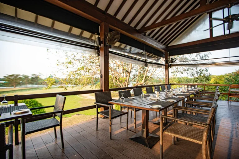 Open-sided dining terrace overlooking the grounds at Waters Edge